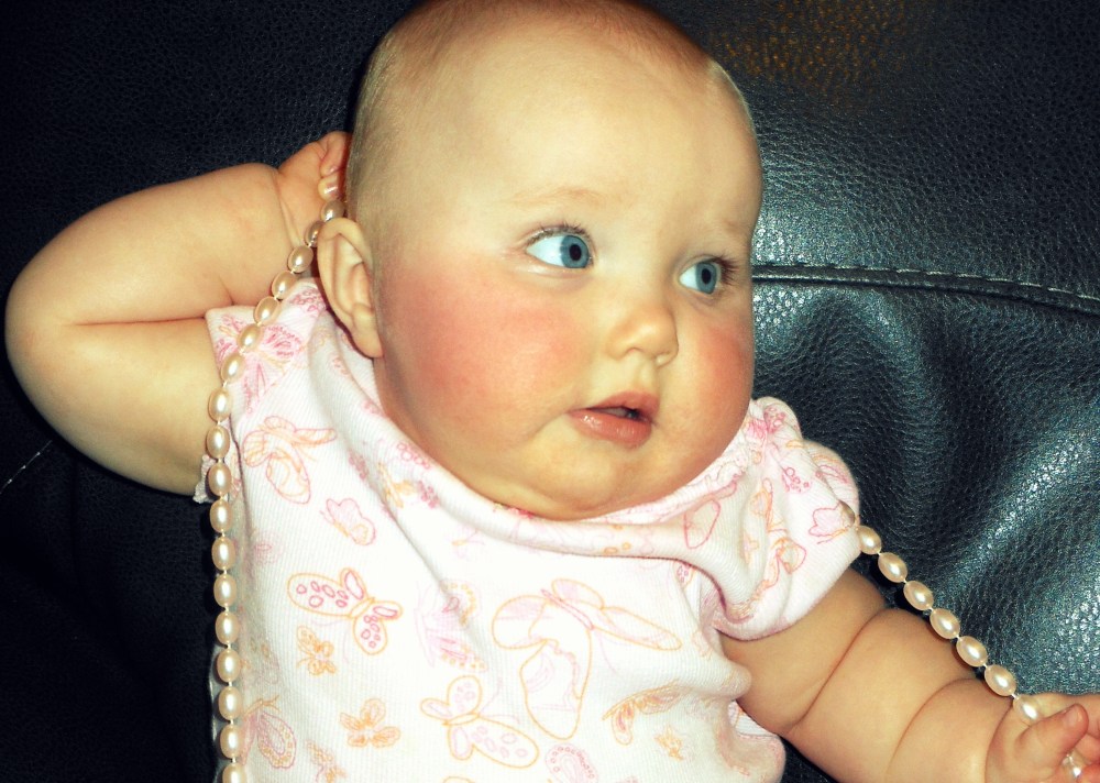 Baby wearing pearls